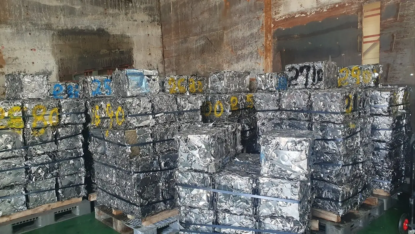 Baled stainless steel scrap stacked in a warehouse